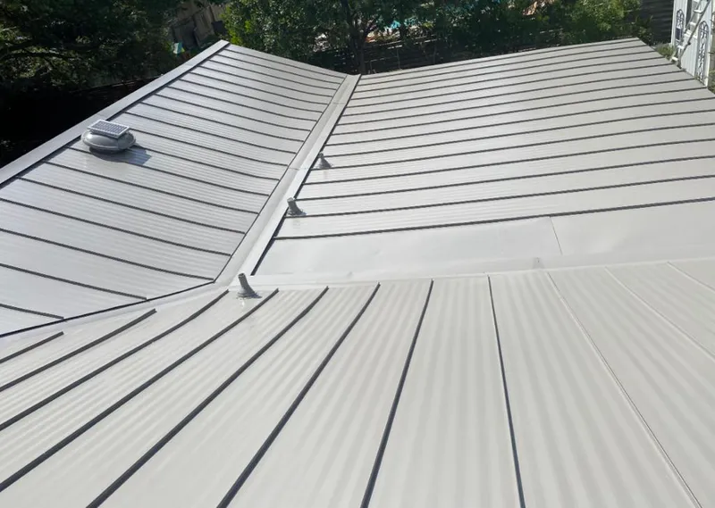 Solar attic fan installed on a metal roof for Roof Ventilation in Sulphur